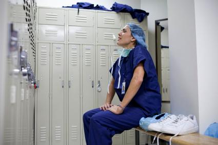 Stressed medical professional in employee room