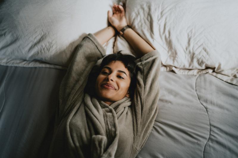 young woman resting on her bed