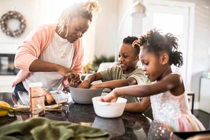 Family mixing cookie dough at home