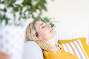 Woman with eyes closed relaxing at home