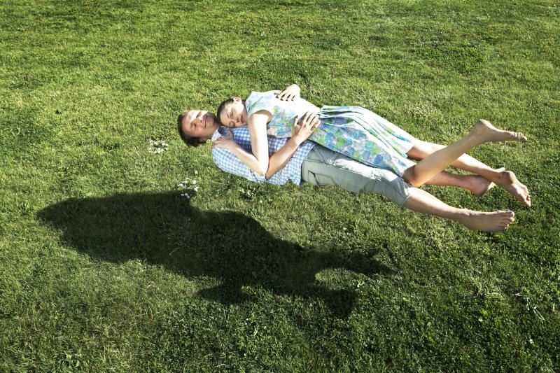 Man and woman floating above the grass