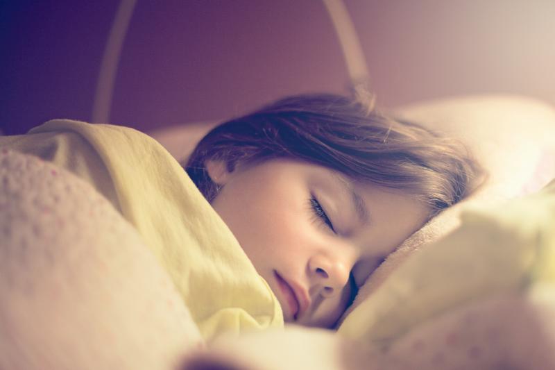 Little girl sleeping in her bed
