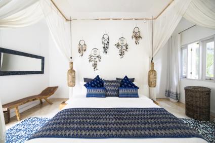 Cozy airy bedroom with blue pillows and dreamcatchers