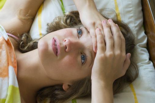 Young woman lying on bed