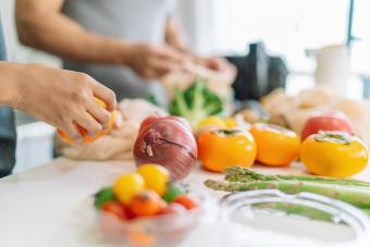 Close-up photo of woman's hand while preparing vegan food at home