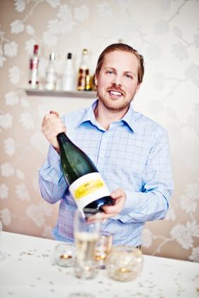 man holding large champagne bottle