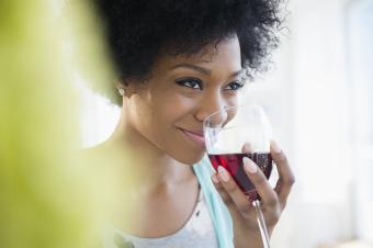 woman sniffing red wine