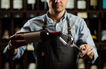 Server pouring wine