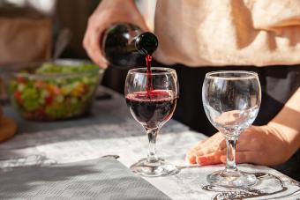 Woman pouring wine into glasses