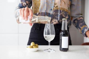 woman pouring glass of white wine