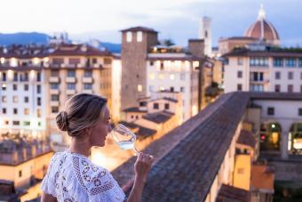 Woman enjoying a glass of wine with the view of Florence