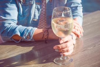 Girl holding a glass of white wine