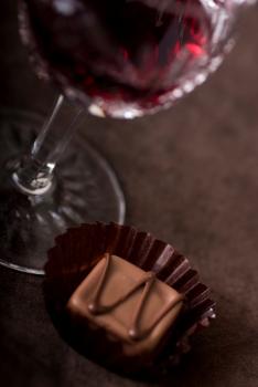 Glass of red wine with chocolate candy