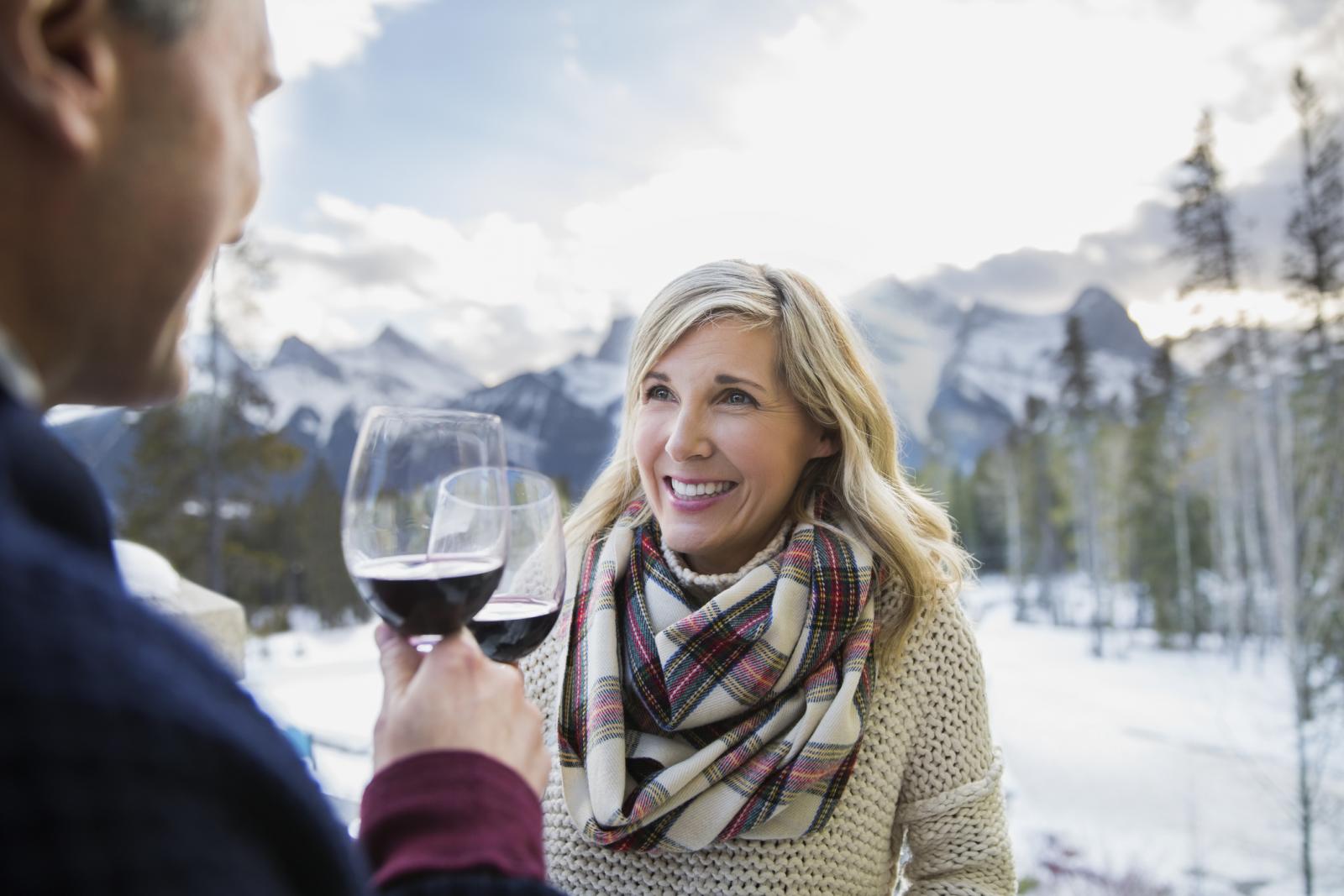 Couple in winter with red wine
