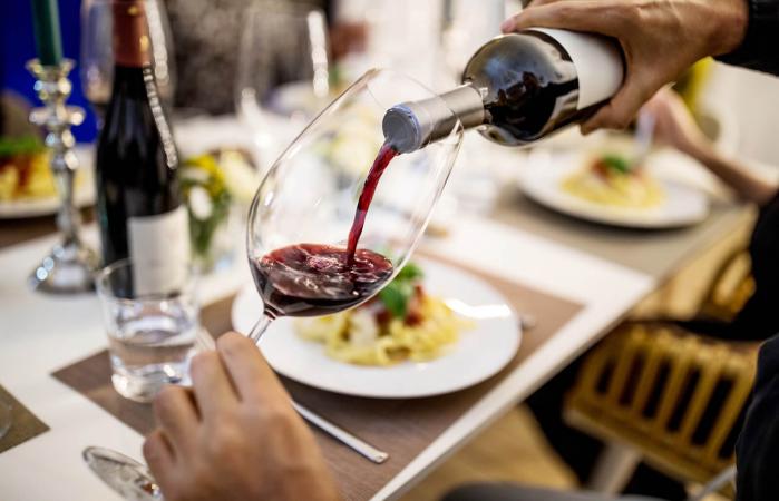 Man pouring red wine in glass