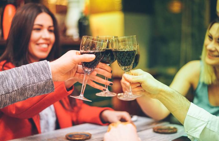 Friends raising toast with wine