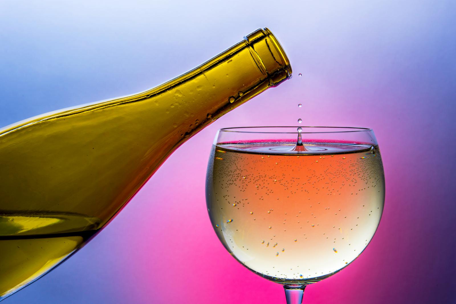Wine dripping from bottle into glass