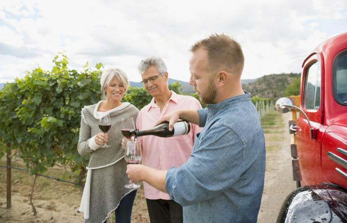 Vintner pouring red wine