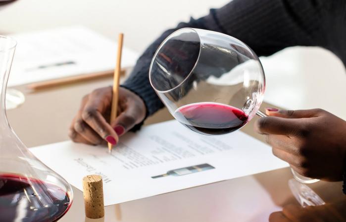 woman evaluating red wine