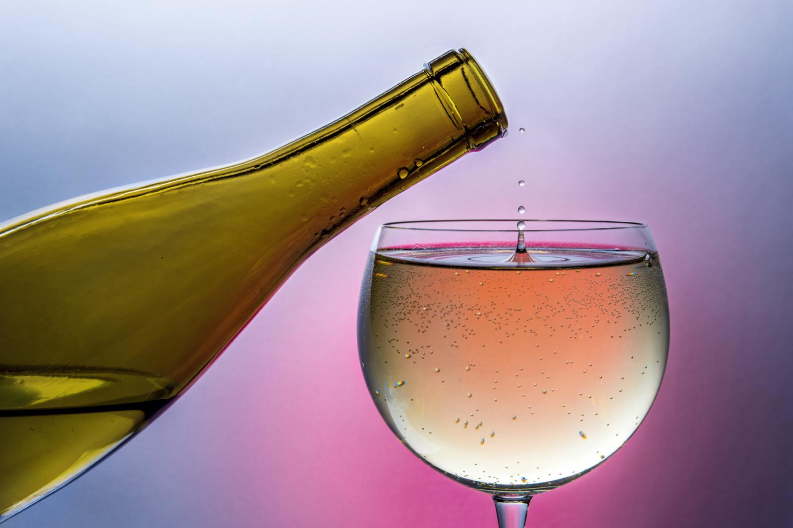 Wine dripping from bottle into glass