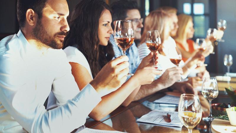 group tasting different types of wine at a winery