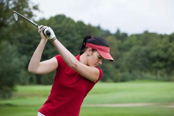 Woman wearing red golf visor