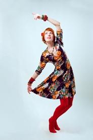 Woman dancing in a flowy dress and tights