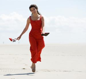 Woman wearing a red sundress at the beach