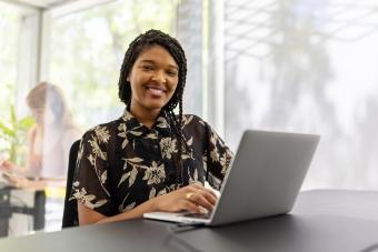 Smiling young woman sitting office desk