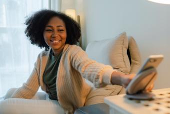 Woman putting her smartphone on wireless charger 