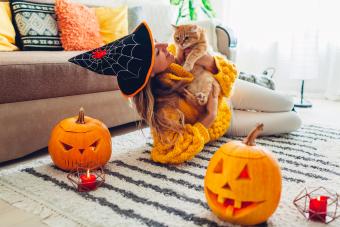 Woman with cat and Halloween decorations