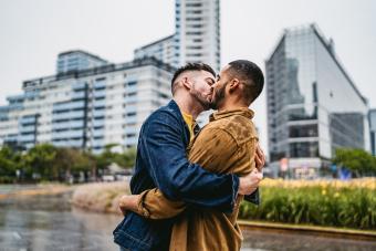 couple standing on city street kissing