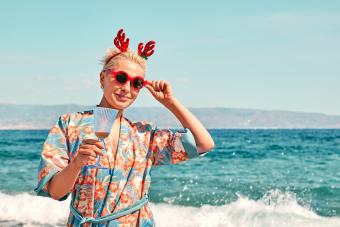 Funny young woman wearing christmas costume and sunglasses