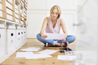 Woman sitting on floor creating mood board