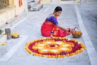 Woman hand lighting diva's in Diwali