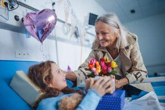 Grandmother visiting her sick granddaughter in hospital