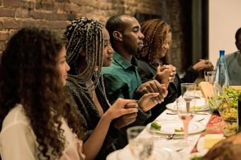 family saying grace for Thanksgiving dinner