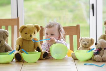 Toddler playing with toys at meal time