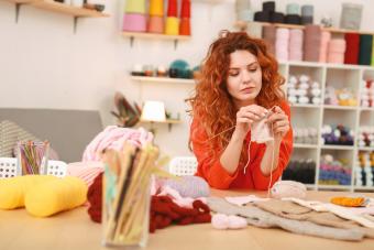 Woman knits at a table