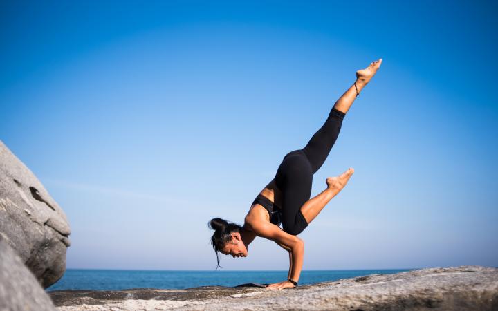 Woman Exercising On Beach