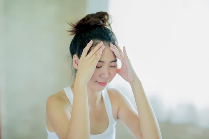 woman massaging her head