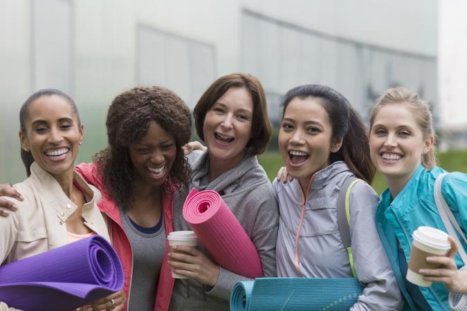 happy women with yoga mats