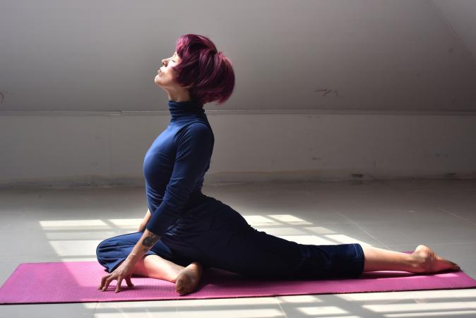 Woman doing half pigeon pose in yoga
